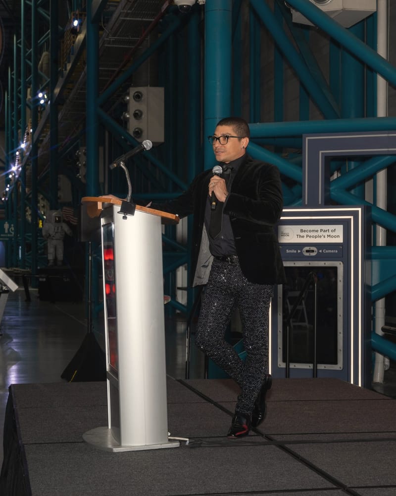 Jerry Nieves speaking at a podium on stage